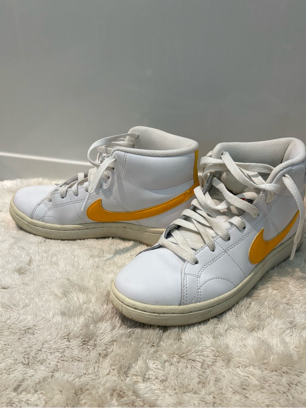 Nike White High-Top Sneakers with Yellow Swoosh
